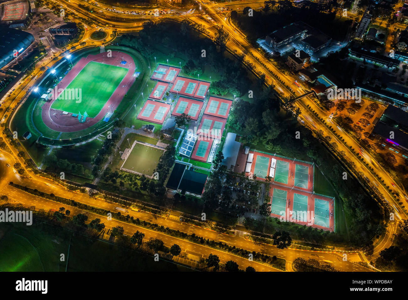 Aerial view of football stadium and tennis courts in the middle of