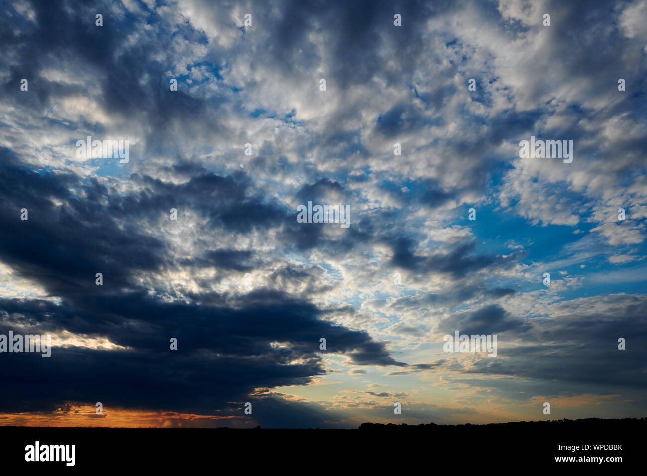 Beautiful sunset - dark sky with clouds and sunlight Stock Photo - Alamy