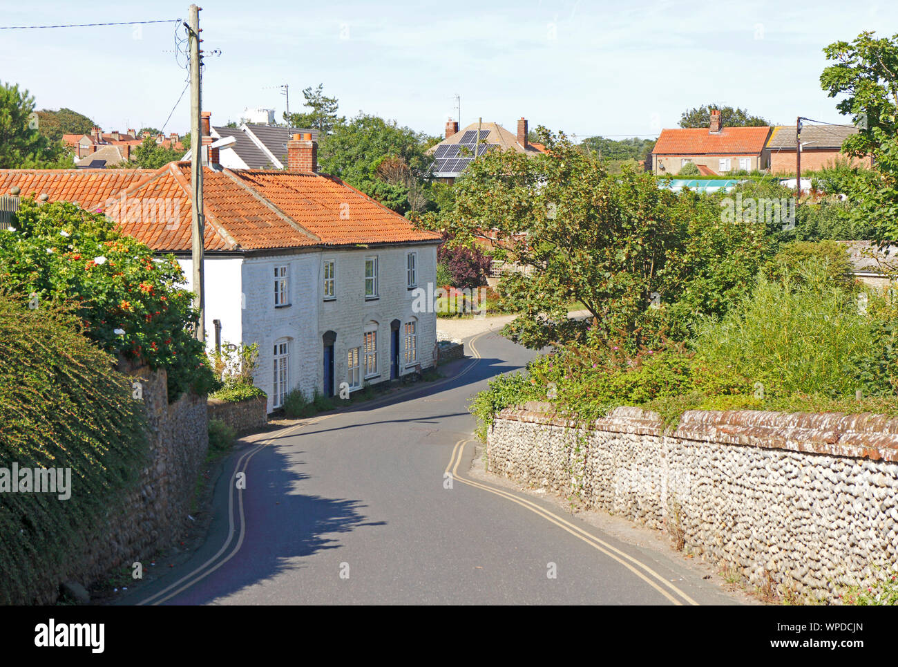 The B1159 coast road passing through The Dell at the east end of the North Norfolk seaside resort of Mundesley, Norfolk, England, UK, Europe. Stock Photo