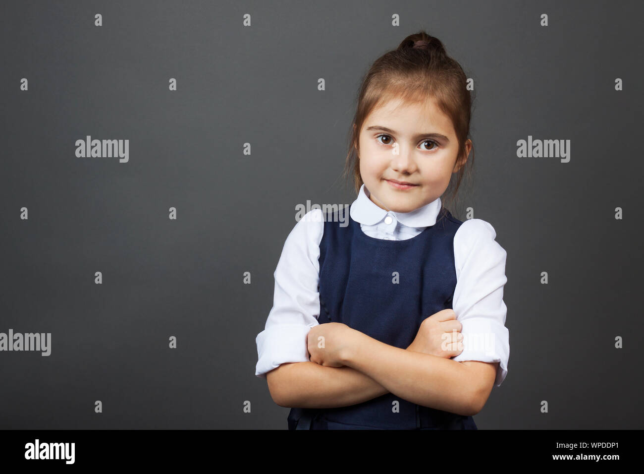 Portrait of a little girl in the school uniform going to school. Copy ...