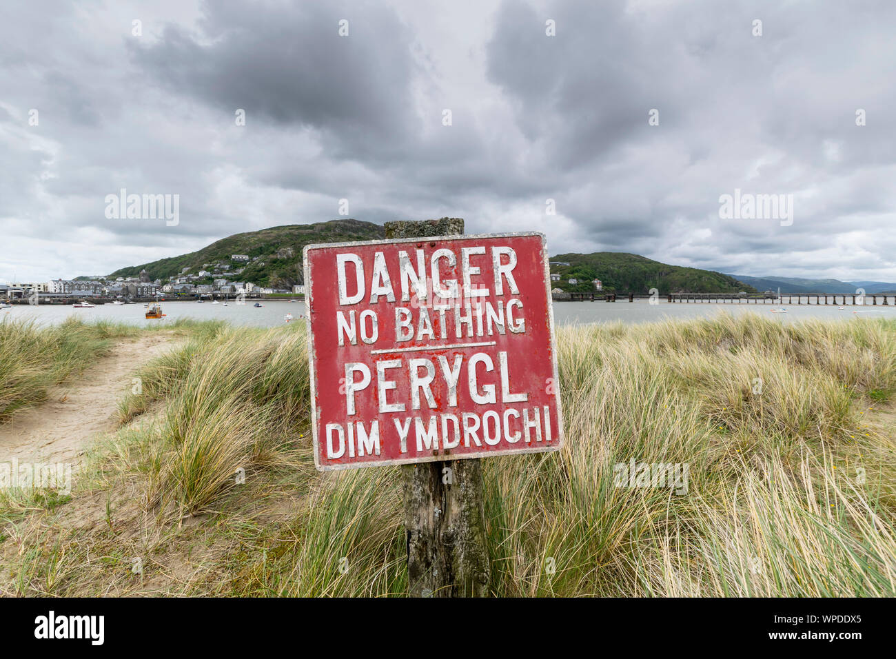 Danger No Bathing Sign on the Mawddach estuary dunes Gwynedd Mid Wales looking towards Barmouth Stock Photo
