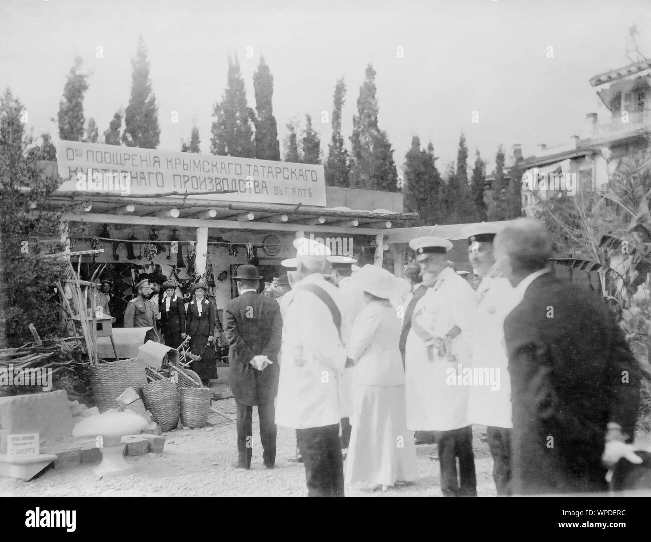 Russian Emperor Nicholas II with family in Yalta, Crimea in the beginning of 20th century. Emperor Nicholas II observing the Society for the Promotion of Crimean Tatar Handicraft Production in Yalta. Stock Photo