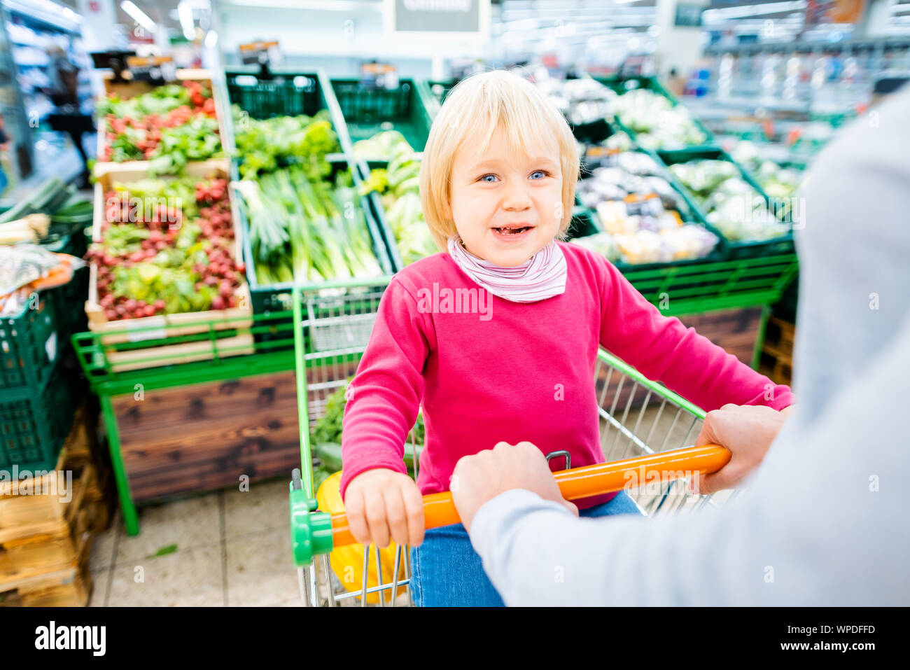 Mother and toddler with shopping cart in supermarket Stock Photo Alamy