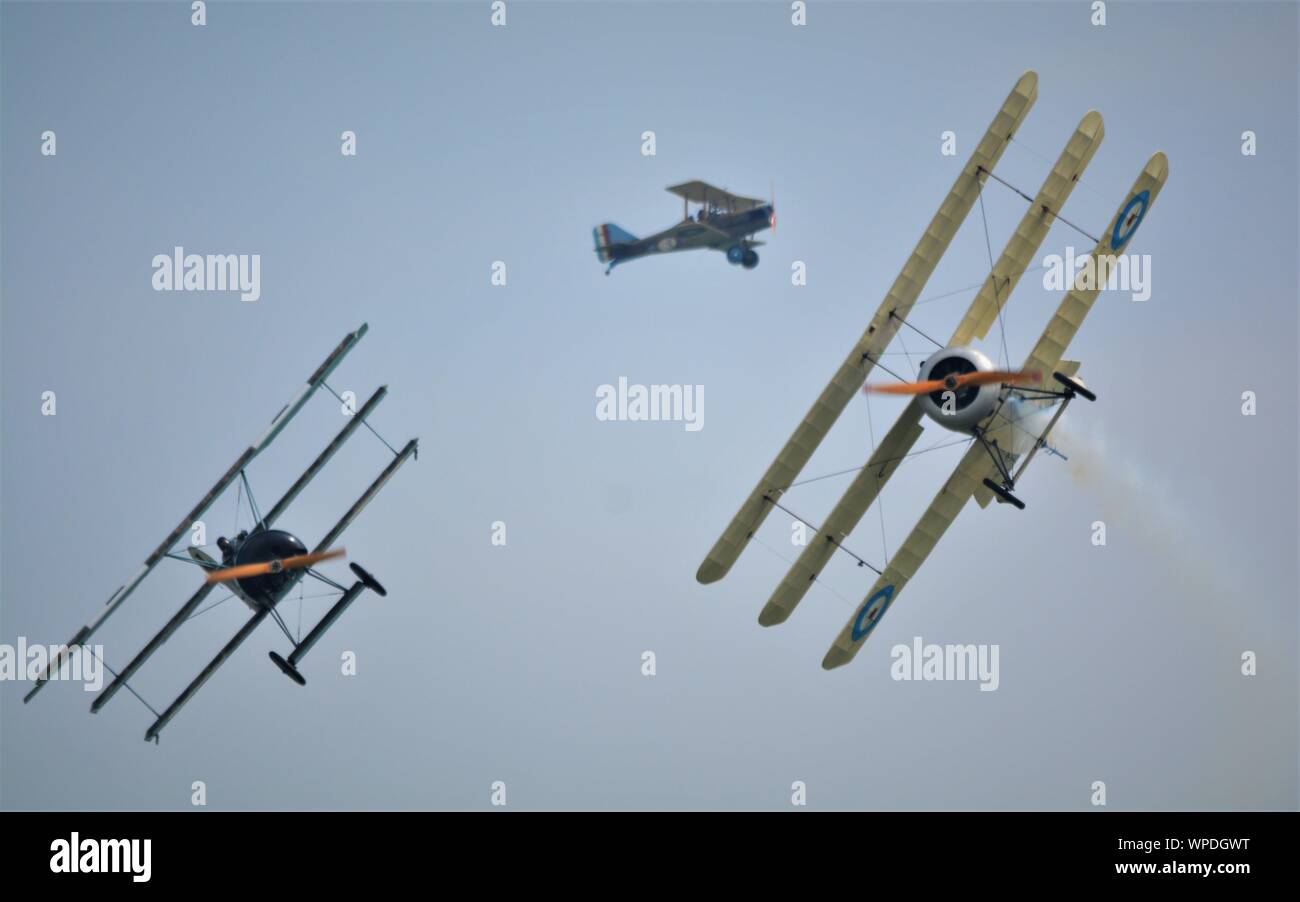 World war 1 aircraft in a dog fight, fokker tri plane and sopwith tri plane. In smokey  skies , reenactment  on early air combat. Stock Photo