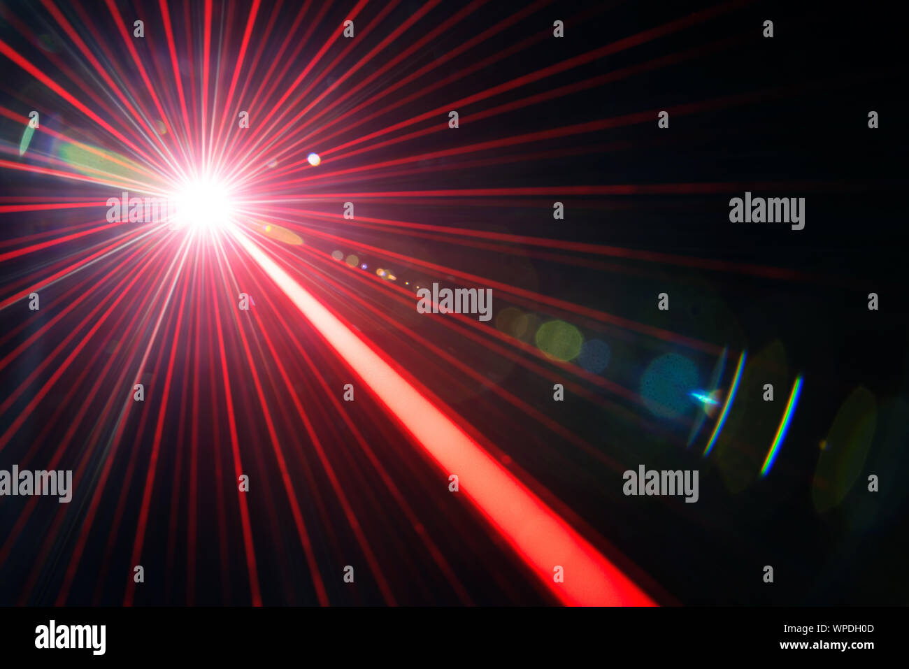 Red laser beam light effect with flares on black background Stock Photo
