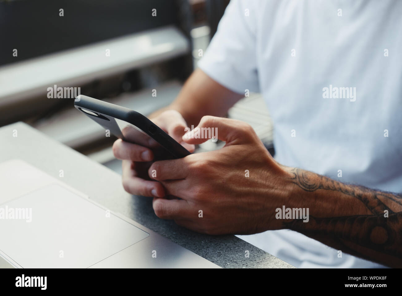 Closeup of a man's hands is holding smartphone and typing text message ...
