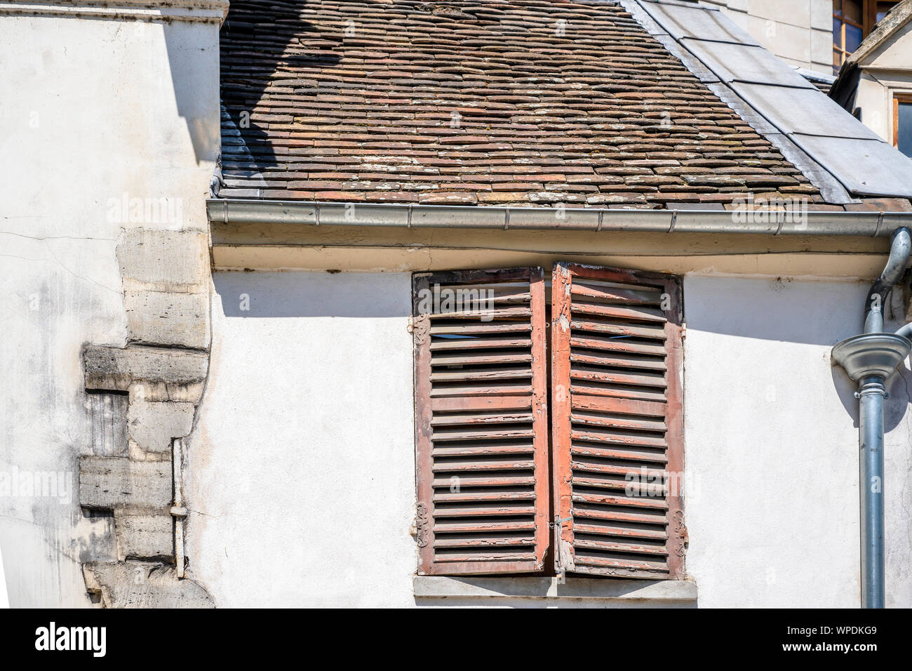 Rotten Shutter Classic houses with peeling stone walls, wooden rotten shutters ...