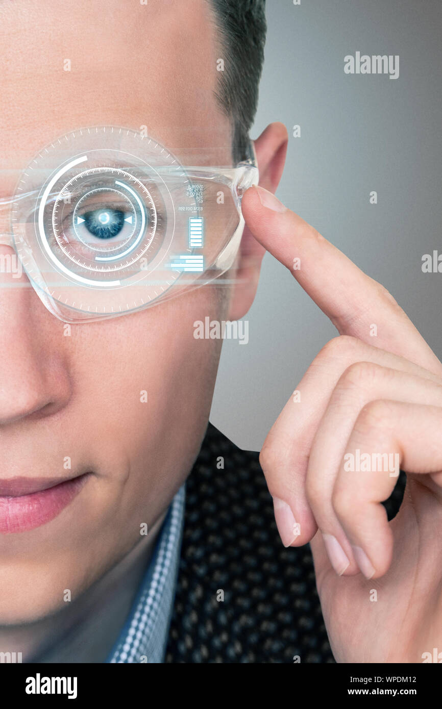 A man in augmented reality glasses with a head up display. Industry 4.0 concept Stock Photo