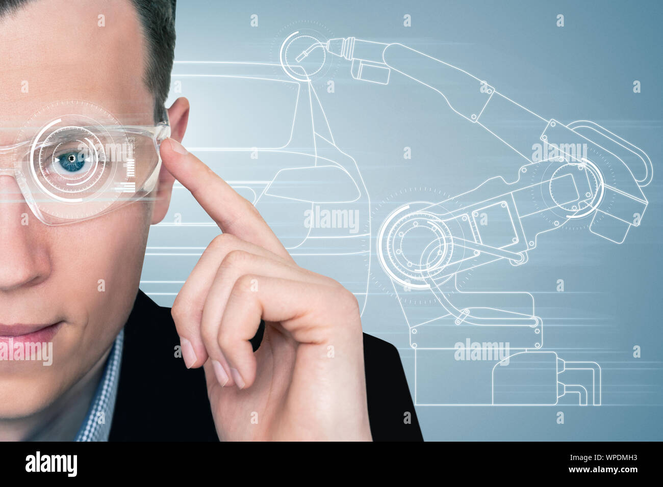 A man in augmented reality glasses with a head up display. Industry 4.0 concept Stock Photo