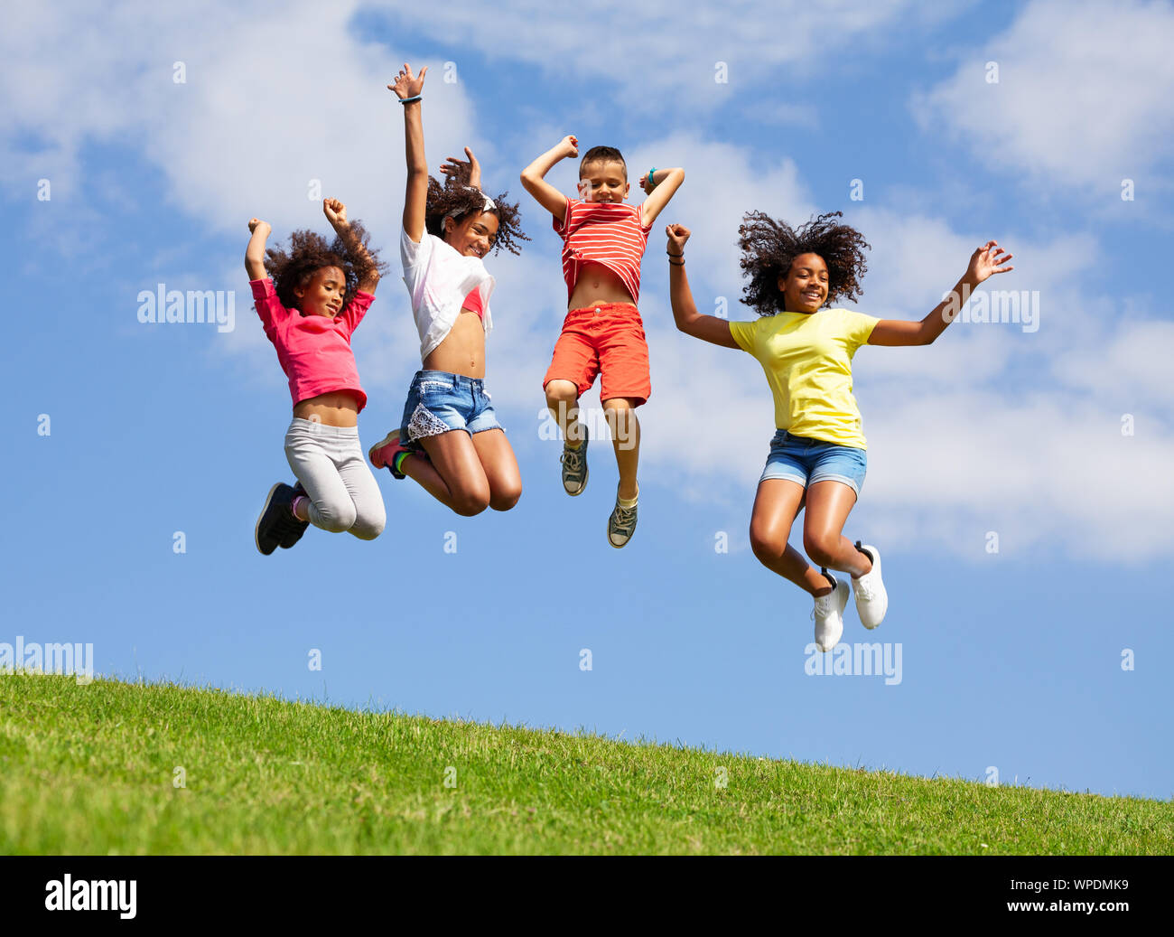 https://c8.alamy.com/comp/WPDMK9/group-four-jumping-kids-over-blue-sky-WPDMK9.jpg