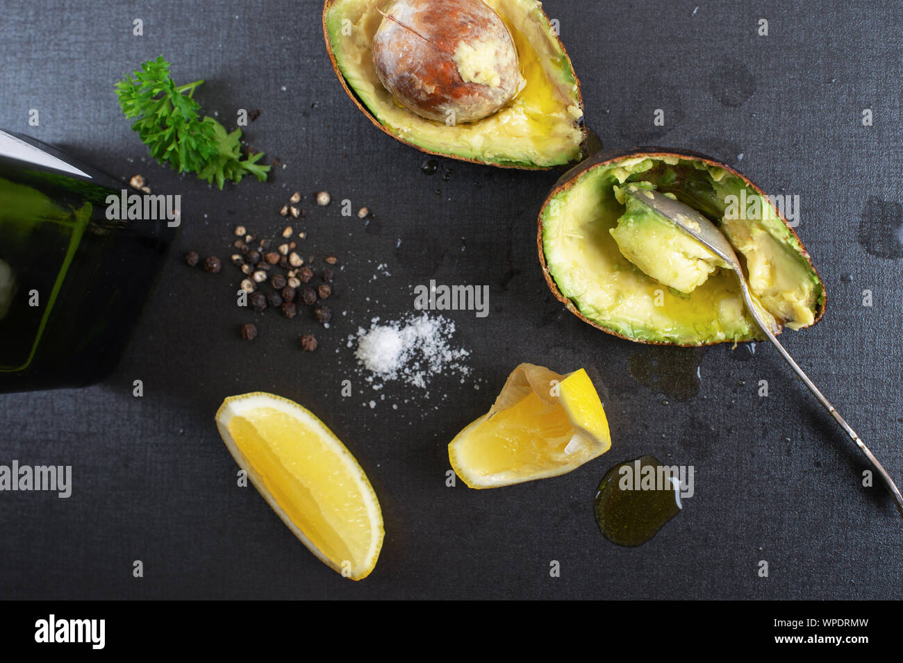 Ripe organic avocado with olive oil, sea salt and black pepper Stock Photo