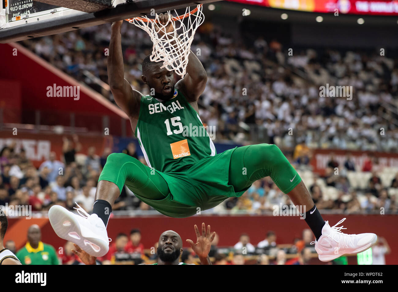 Shanghai, China. 09th Sep, 2019. Basketball: World Cup, Jordan - Senegal,  placement round at Oriental Sports Center. Senegal's Youssoupha Ndoye is  hanging on the basket after a dunking. Credit: Swen Pförtner/dpa/Alamy Live