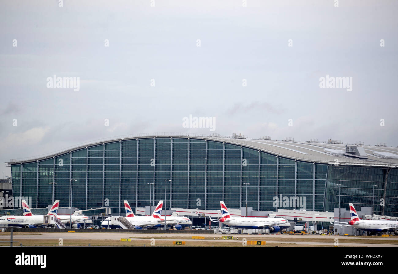 British Airways planes at Terminal Five at Heathrow Airport, London, on day one of the first-ever strike by British Airways pilots. The 48 hour walk out, in a long-running dispute over pay, will cripple flights from Monday, causing travel disruption for tens of thousands of passengers. Stock Photo