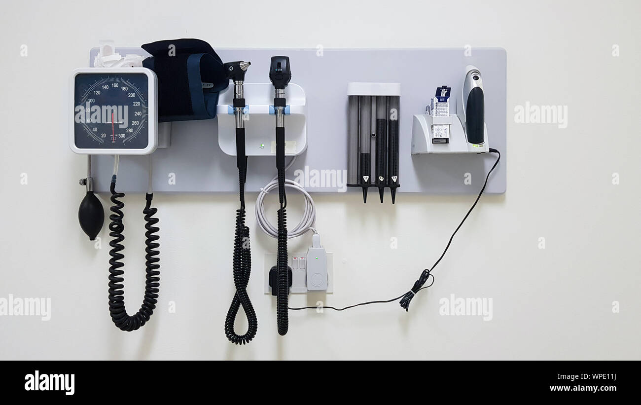 Standard doctor's office equipment mounted to a wall with copy space