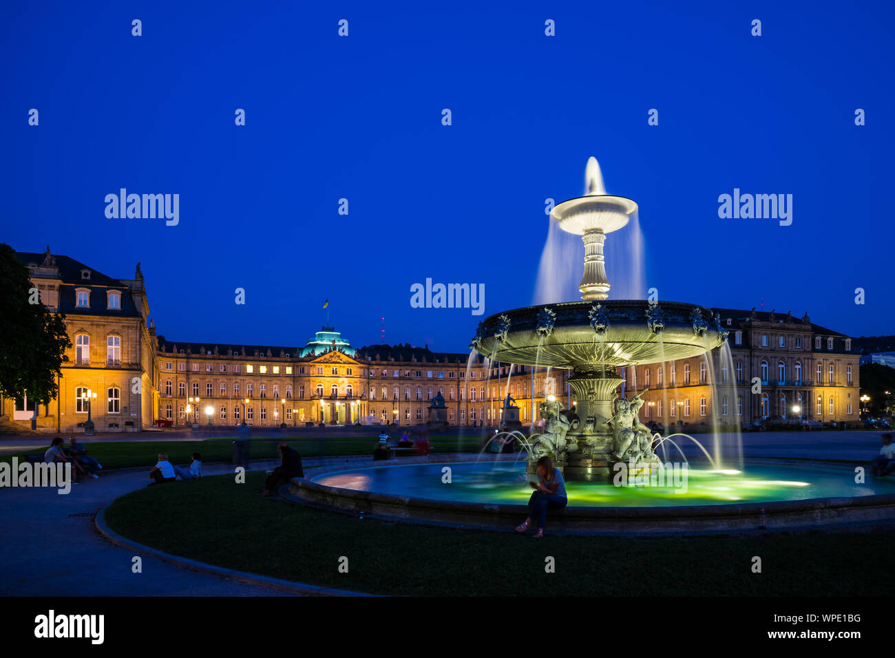 Stuttgart, Germany, August 25, 2019, Illuminated fountain in front of ancient new castle at schlossplatz square after sunset in summer where many peop Stock Photo