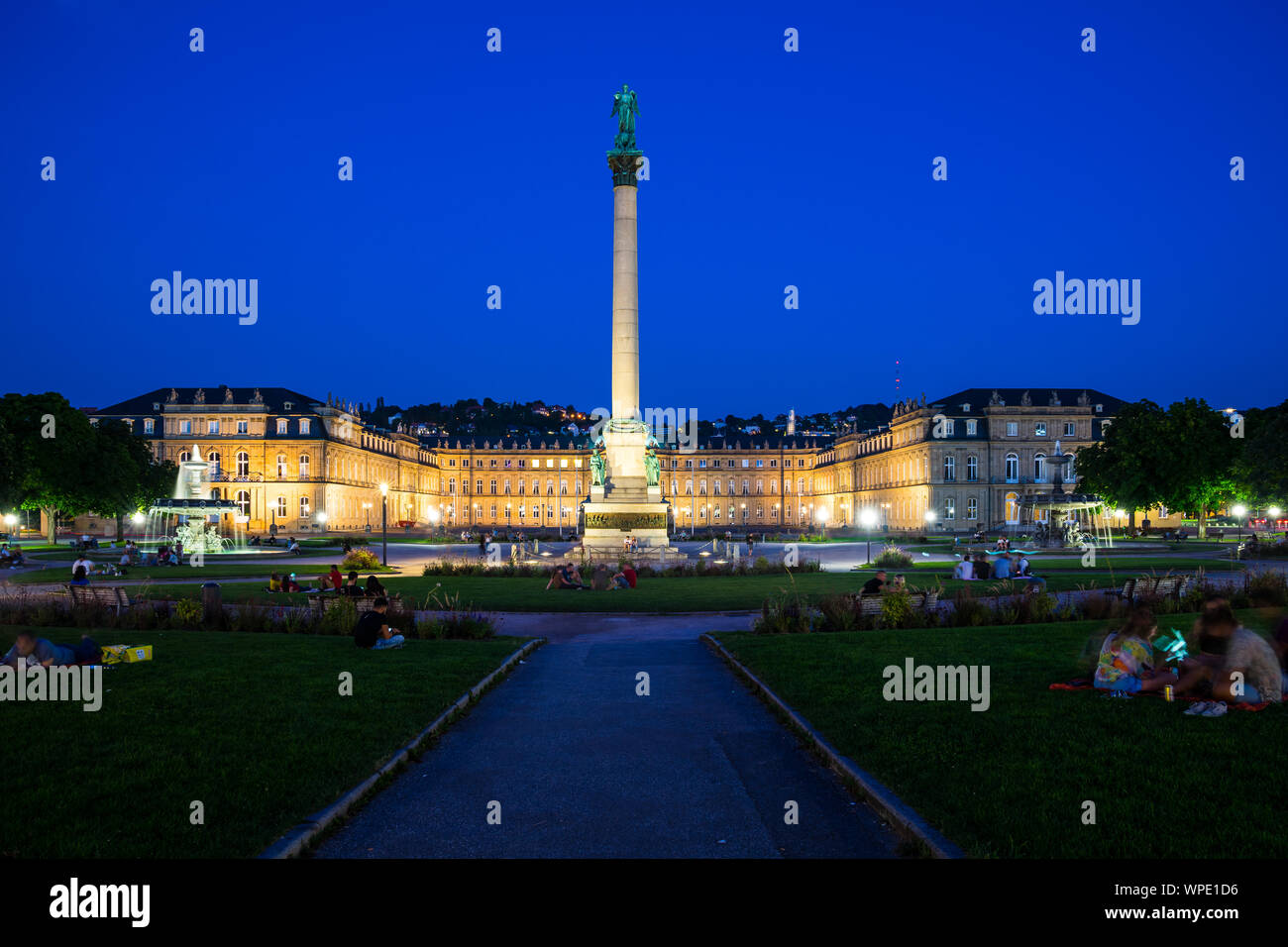 Stuttgart, Germany, August 25, 2019, Magical summer atmosphere at illuminated schlossplatz square by night after sunset with blue sky with many people Stock Photo