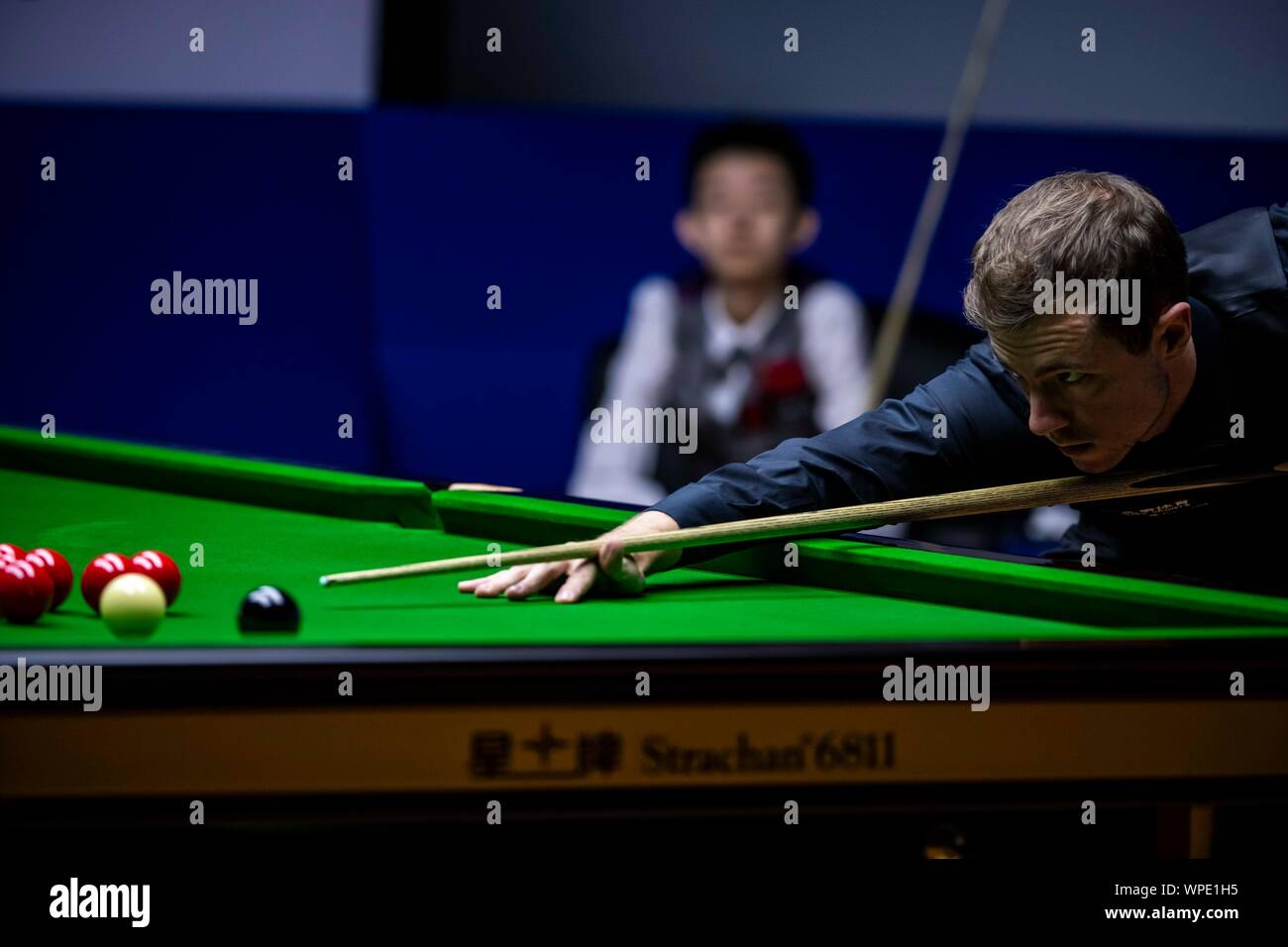 wu yize of china plays a shot to john higgins of scotland in the heldover match during the 2019 world snooker international championship in daqing cit stock photo alamy