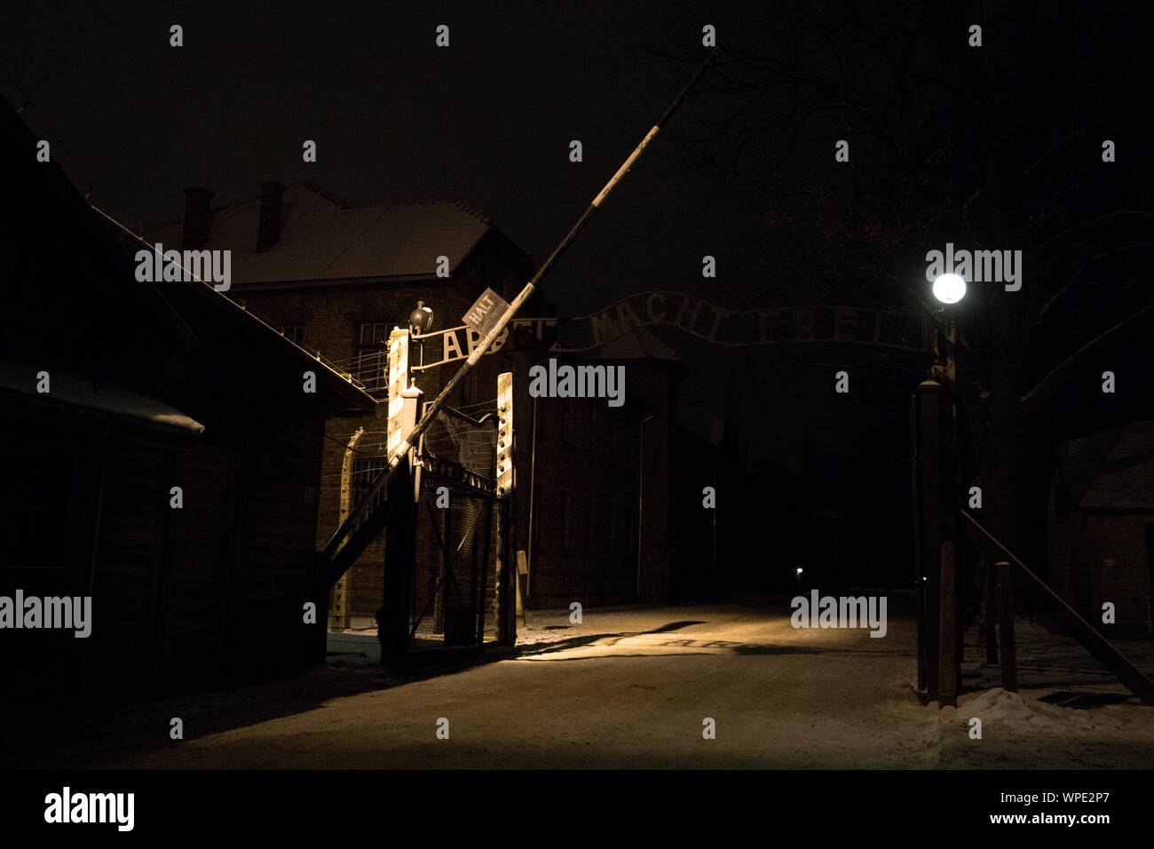 Auschwitz Birkenau, Poland 27 January 2019: Gate Arbeit Macht Frei, Part of Auschwitz Concentration Camp Holocaust Memorial Museum by night in winter Stock Photo