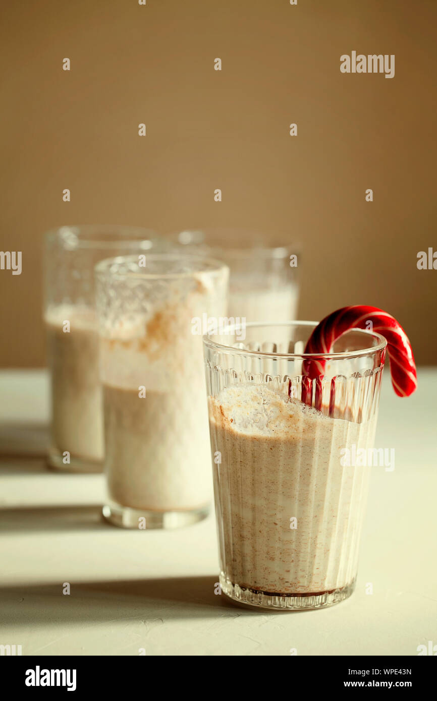 https://c8.alamy.com/comp/WPE43N/traditional-winter-delicious-homemade-christmas-cocktail-eggnog-with-milkrumcinnamon-and-nutmeg-decorated-candy-cane-on-white-background-with-shadow-WPE43N.jpg