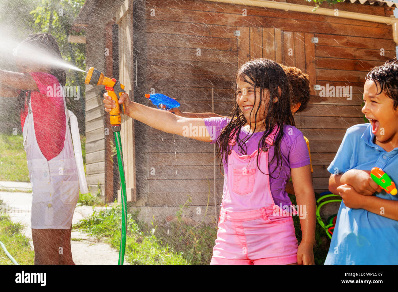 Water gun fight game with girl shoot sprinkler Stock Photo Alamy