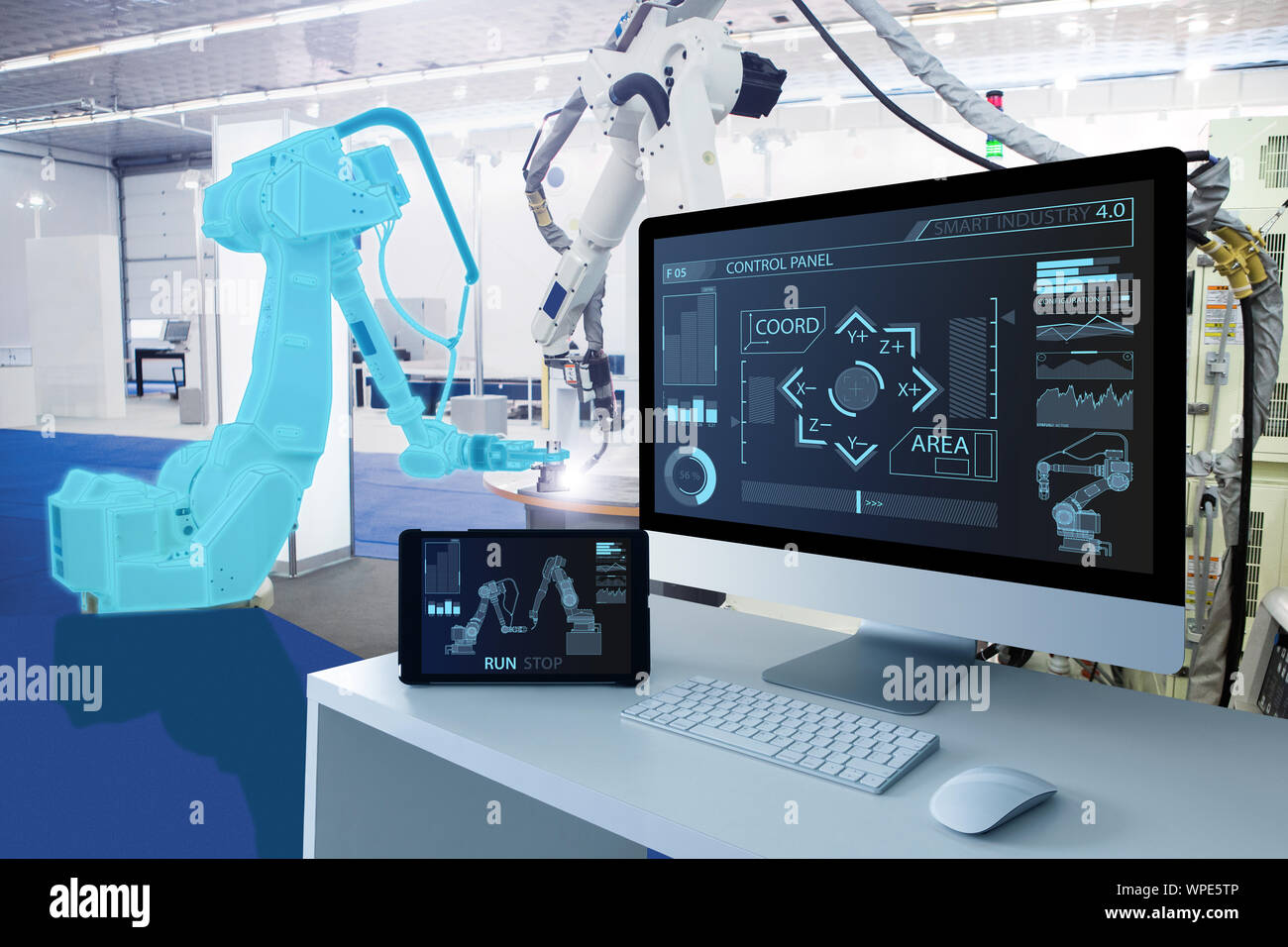 Computer and digital tablet for control of robots in a smart factory. Smart industry 4.0 concept Stock Photo