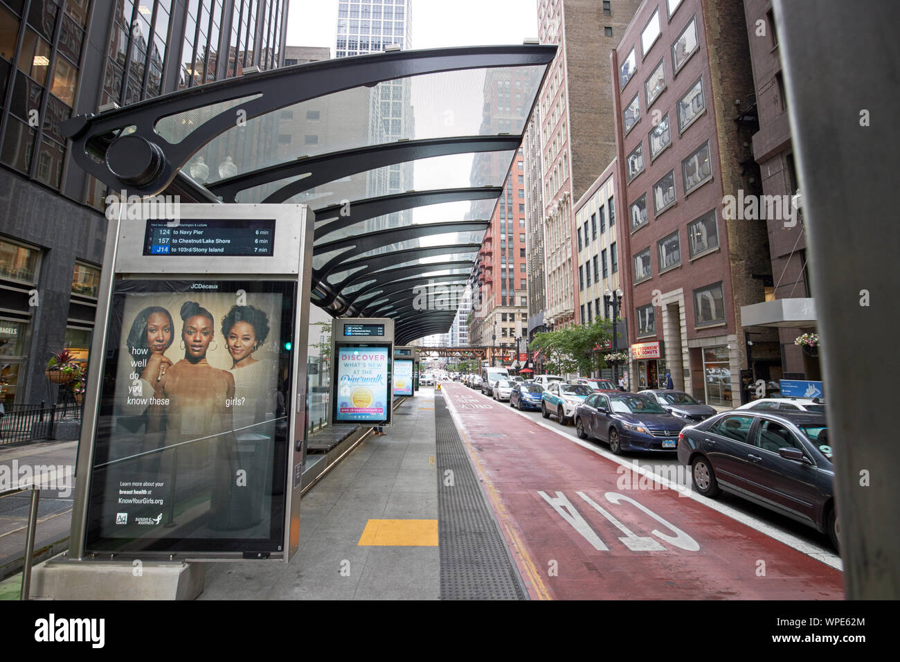 CTA bus stop with empty dedicated bus lane in the middle of west washington street with busy car