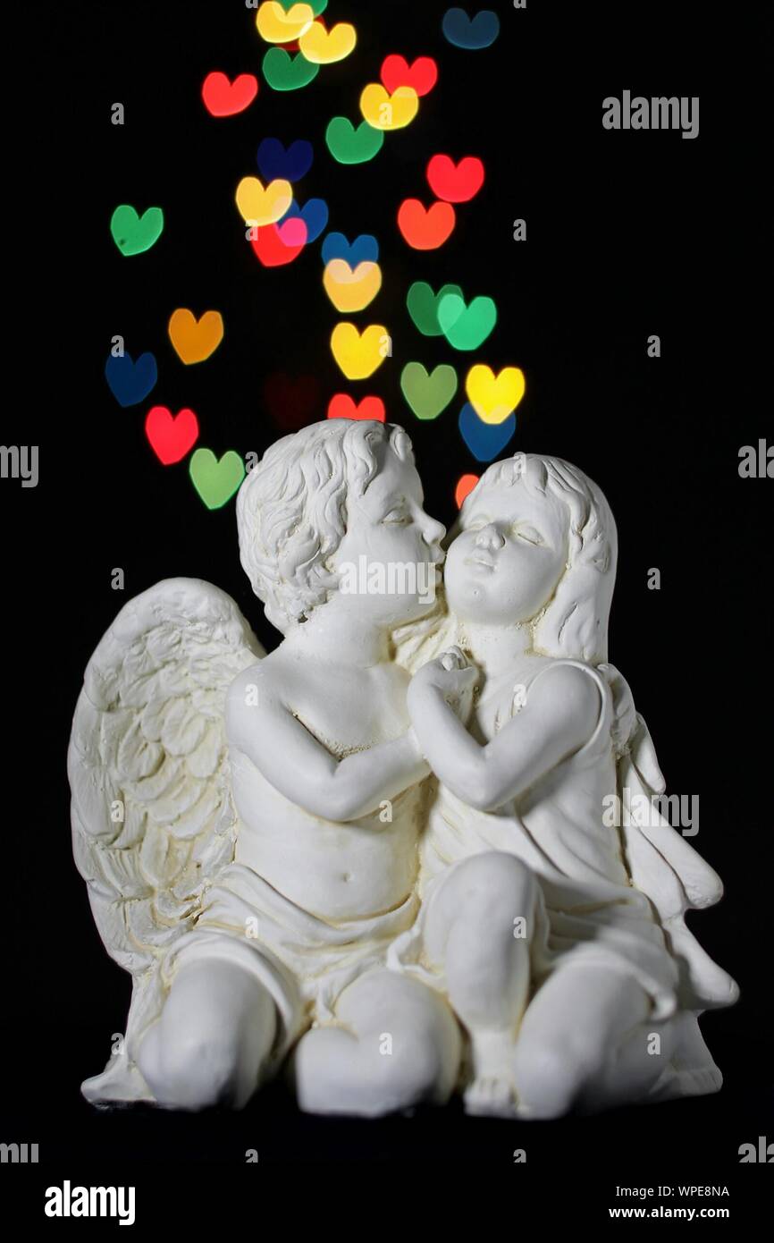 Statue Of Angel Kissing Girl On Black Background Stock Photo Alamy