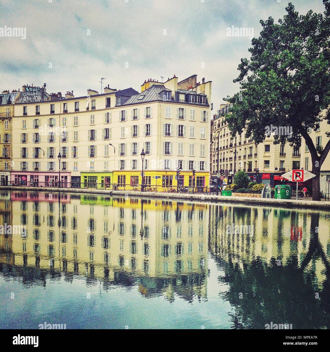 Canal Saint-martin Against Buildings In City Stock Photo