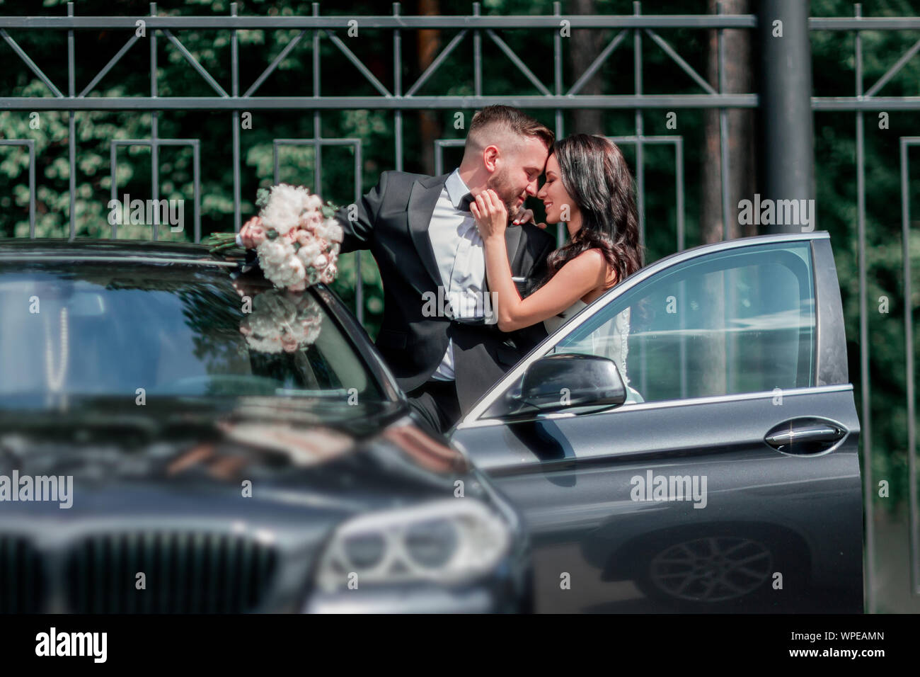 close up. bride and groom standing near the car Stock Photo - Alamy