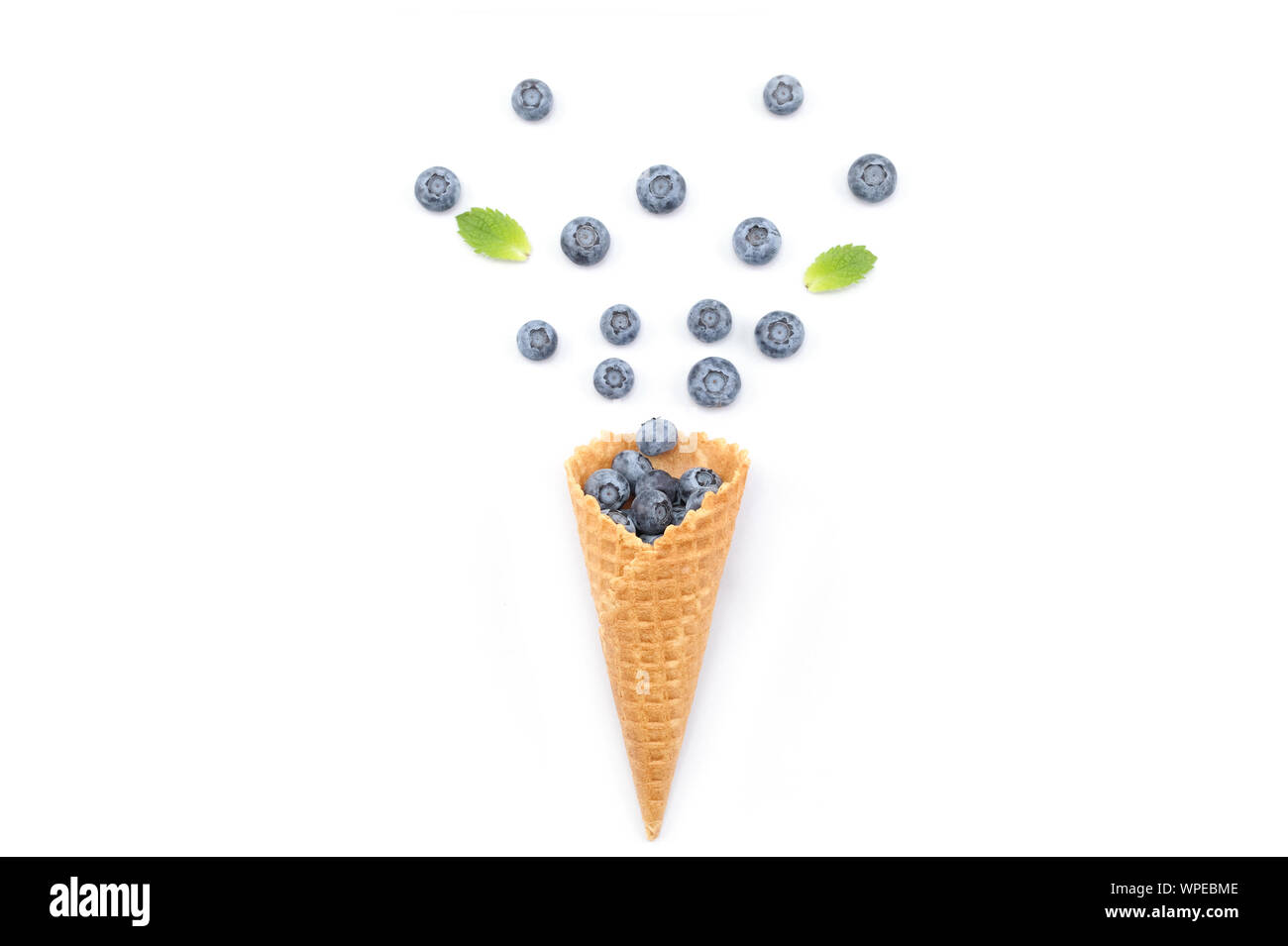 Ice cream wafer cone filled with blueberries. Food concept ,horizontal with copy space.Menu design,food pattern background. Stock Photo