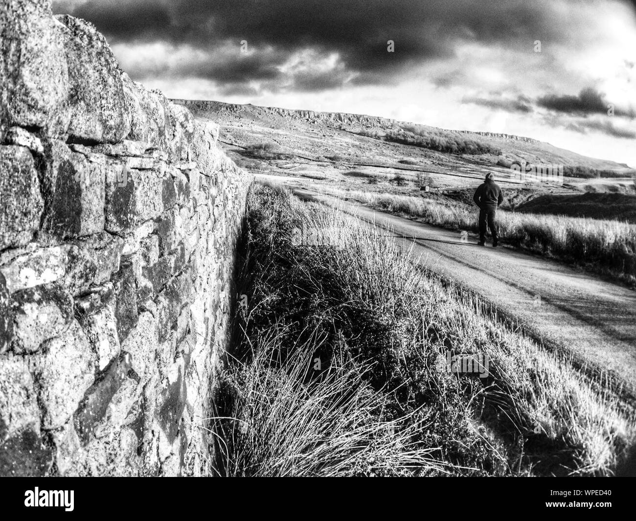 Man walking on country road hi-res stock photography and images - Alamy
