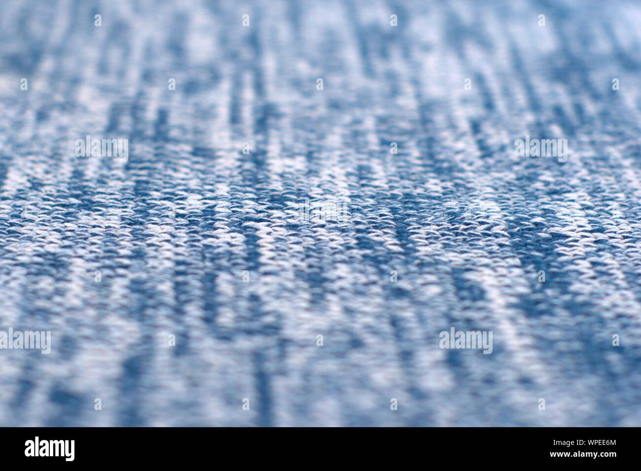 Mottled blue and white woollen sweater. Texture detail close up. Stock Photo