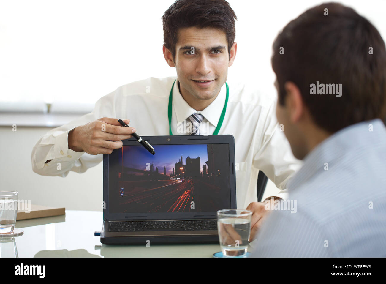 Real estate agent showing house plan on laptop Stock Photo Alamy