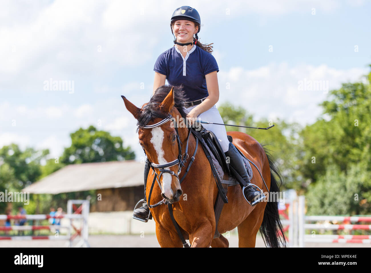 Young female horse rider on equestrian sport competition Stock Photo