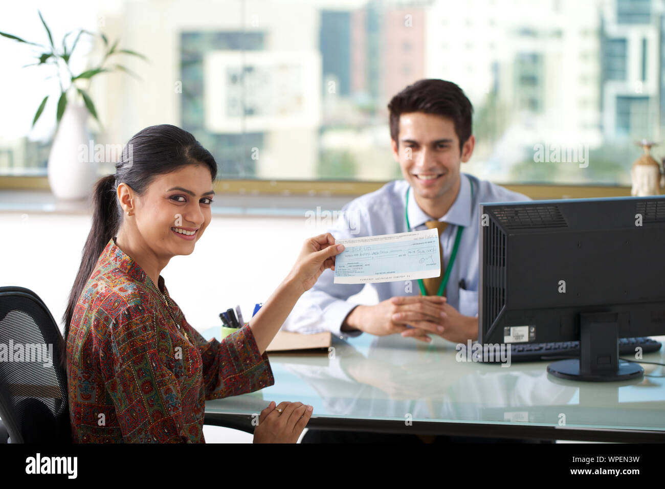 Young woman showing loan cheque Stock Photo - Alamy