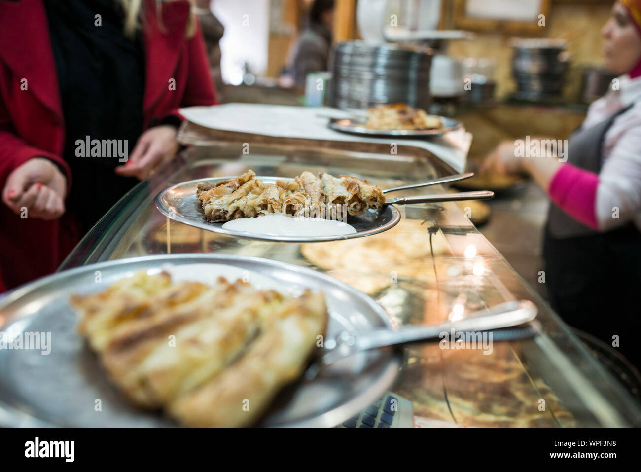 Bosnian traditional fast, street food: Bosnian pie and cevapcici served in restaurant cevabdzinica and buregdzinica Stock Photo