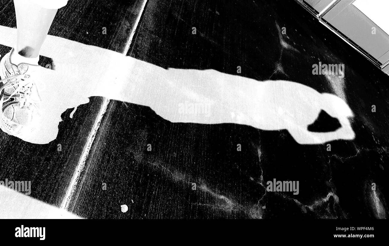 Shadow Of Person Drinking On Pavement Stock Photo Alamy