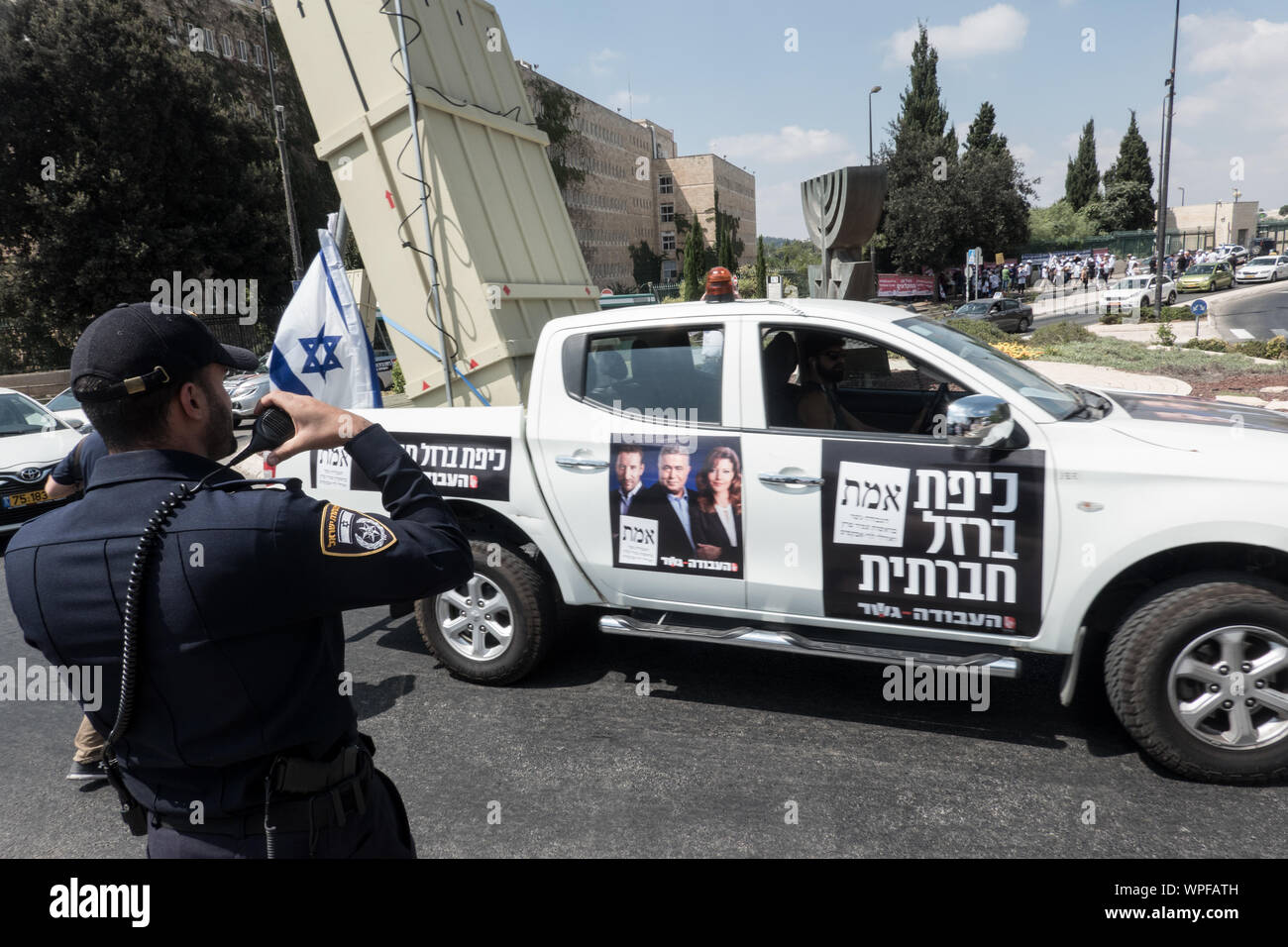 Jerusalem, Israel. 9th September, 2019. Labor Party activists drive pickup trucks with mock up Iron Dome launchers demanding social security while partially blocking the access road to the Israeli Parliament protesting against PM Netanyahu and  citing criminal suspicions, immoral campaigning and a blitz attempt to legislate the allowance of cameras inside election ballot booths. An assortment of political parties demonstrated in front of the Israeli Parliament building with similar messages ahead of round two of the national elections for parliament scheduled for 17th September, 2019. Credit:  Stock Photo