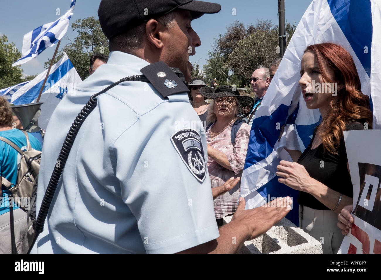 Jerusalem, Israel. 9th September, 2019. STAV SHAFFIR (R), former Labor MK and leader of 2011 Israeli social justice protests, number 2 on the the Democratic Union list, exchanges words with a police officer as activists block the access road to the Israeli Parliament. Credit: Nir Alon/Alamy Live News Stock Photo