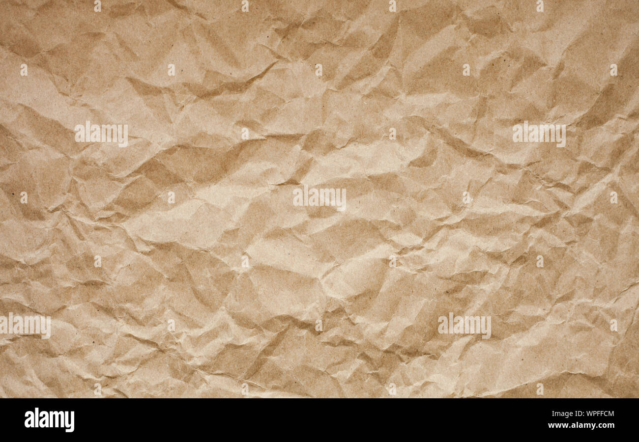 Brown crumpled paper background. Old paper texture. Ancient page pattern. Stock Photo