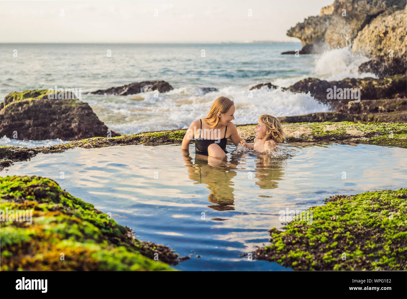 Mother And Son Tourists On Pantai Tegal Wangi Beach Sitting In A Bath Of Sea Water Bali Island Indonesia Bali Travel Concept Traveling With Wpg1e2 Jpg