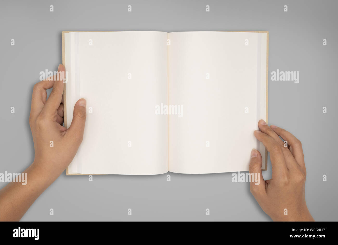 Top view- two hands hold a empty book spread. Stock Photo