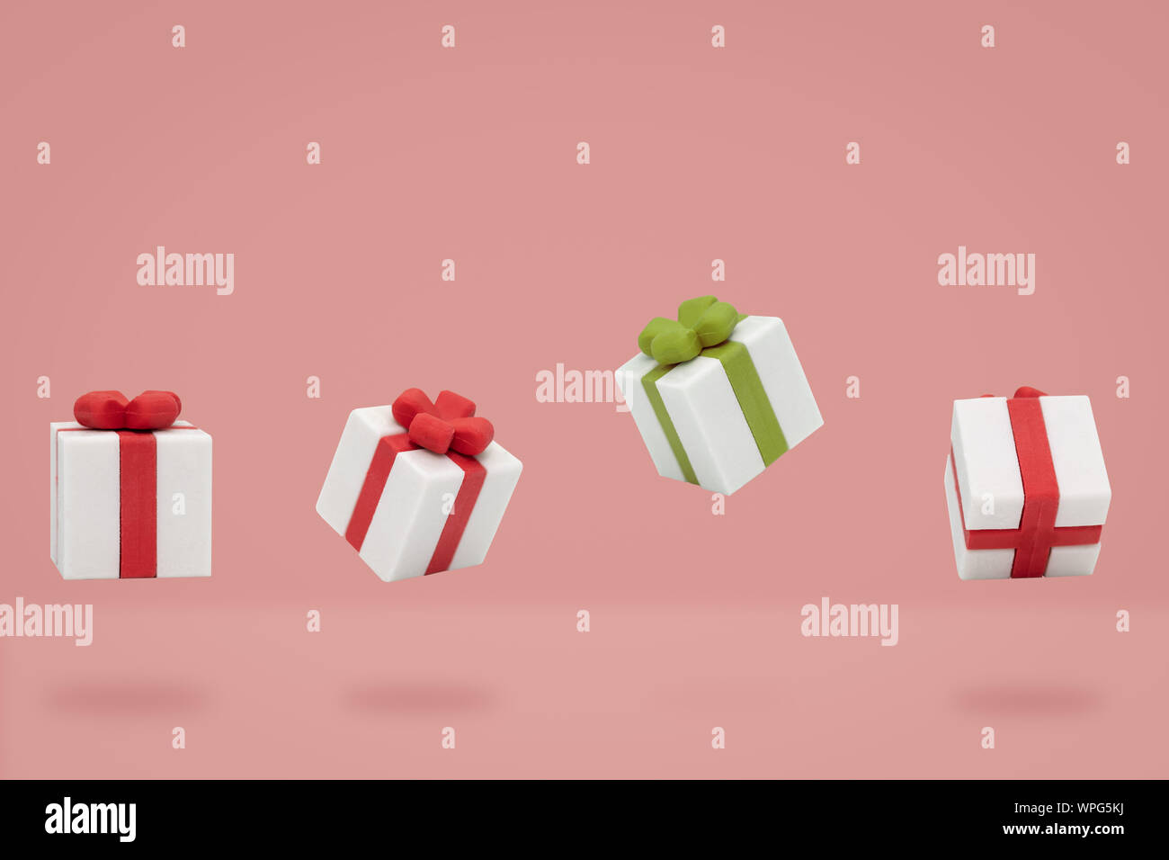 christmas gift boxes is flying on pink backdrop, Minimal composition. Stock Photo