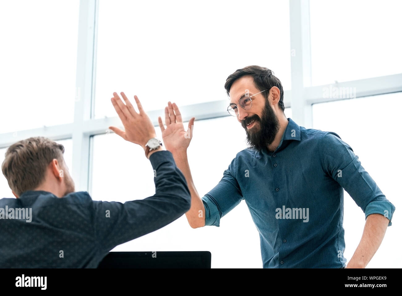business colleagues giving each other a high five Stock Photo
