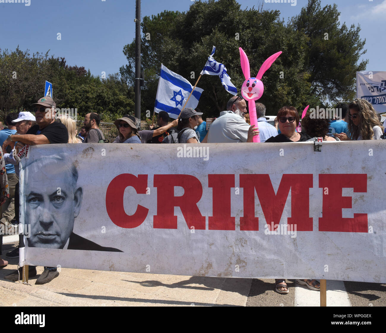 Jerusalem, Israel. 09th Sep, 2019. Supporters of the Democratic Union Party hold a banner with photos of Israeli Prime Minister Benjamin Netanyahu, reading 'CRIME MINISTER' at a protest outside the Knesset, the Parliament, in Jerusalem, Monday, September 9, 2019. The protesters called on Israelis to save Israel's democracy by voting Netanyahu out of office. Israelis return to the polls on September 17, for the second national election in 2019. Photo by Debbie Hill/UPI Credit: UPI/Alamy Live News Stock Photo