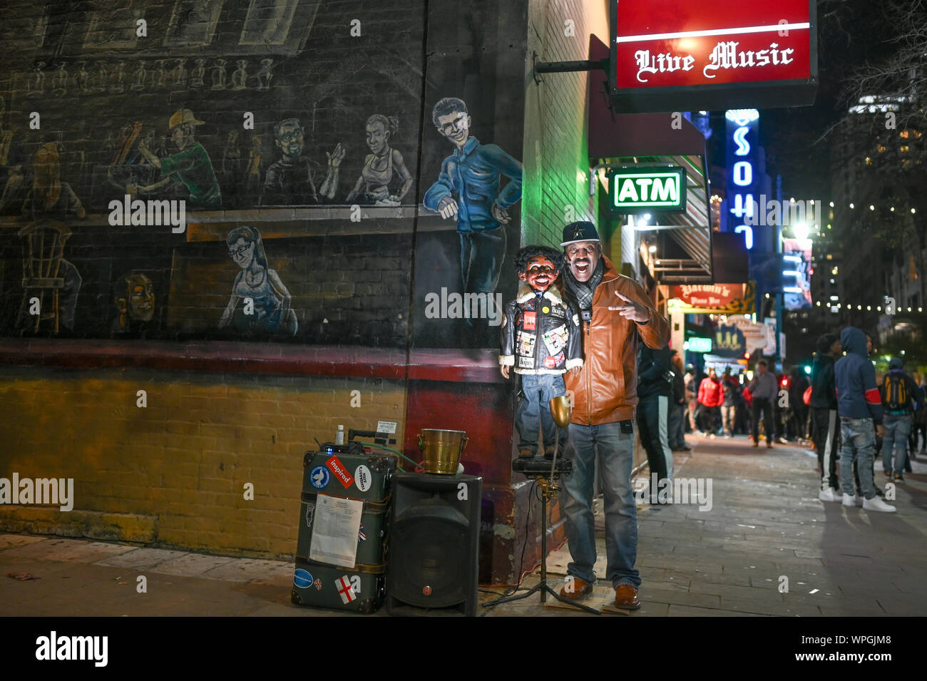 Ventriloquist on Sixth Street by night in Austin Texas during SXSW