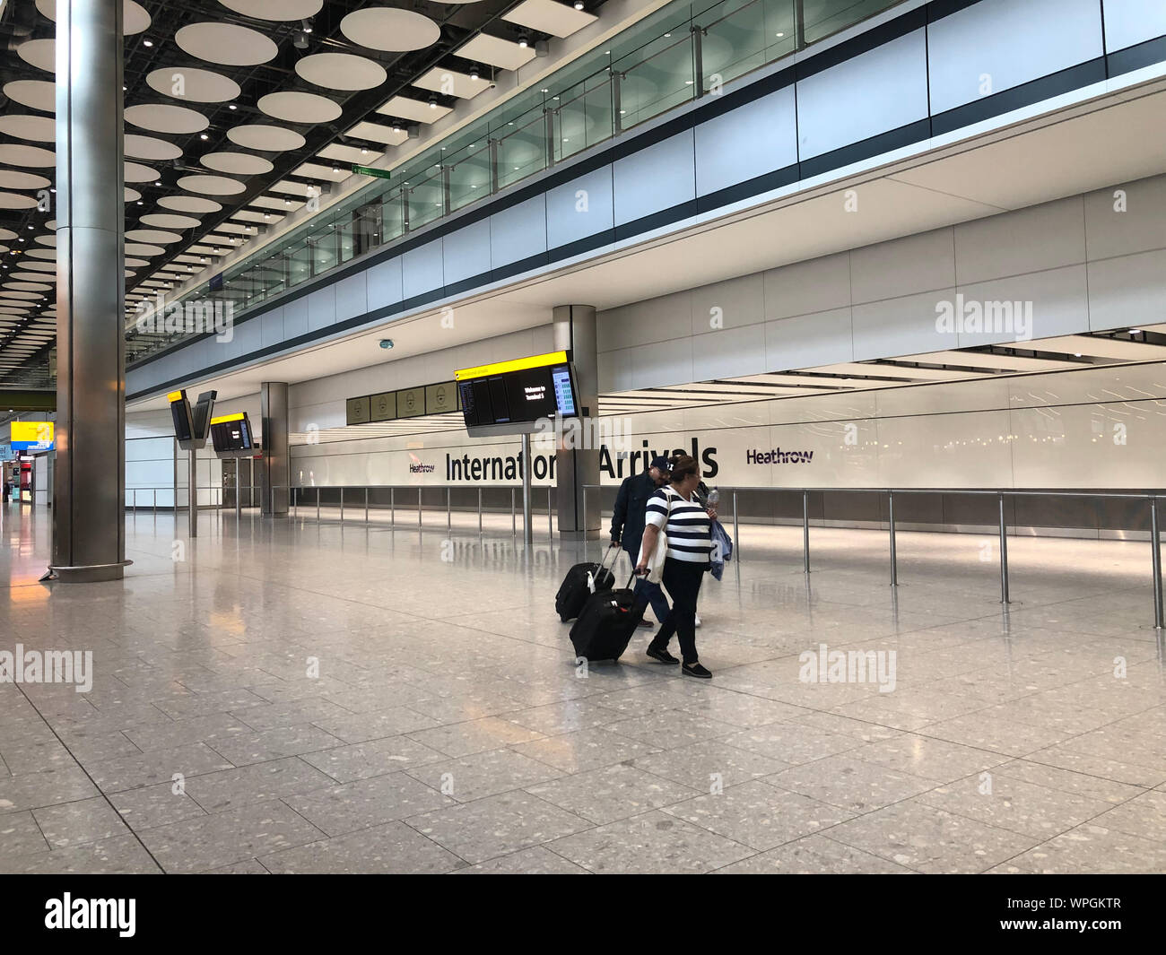 The Arrivals Hall in Terminal Five at Heathrow Airport, London, on day one of the first-ever strike by British Airways pilots. The 48 hour walk out, in a long-running dispute over pay, will cripple flights from Monday, causing travel disruption for tens of thousands of passengers. Stock Photo