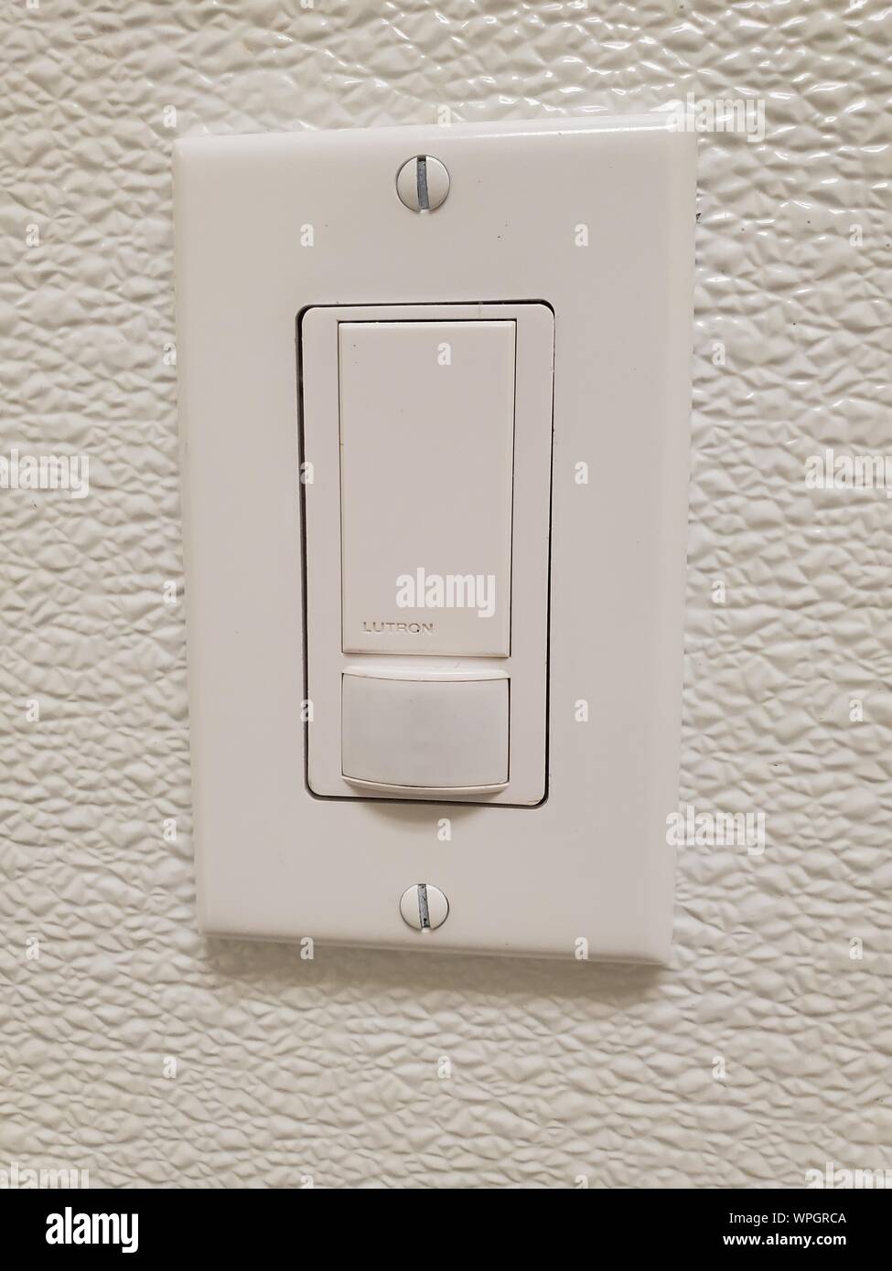 Closeup of motion sensing light switch from Lutron installed on white wall, September 5, 2019