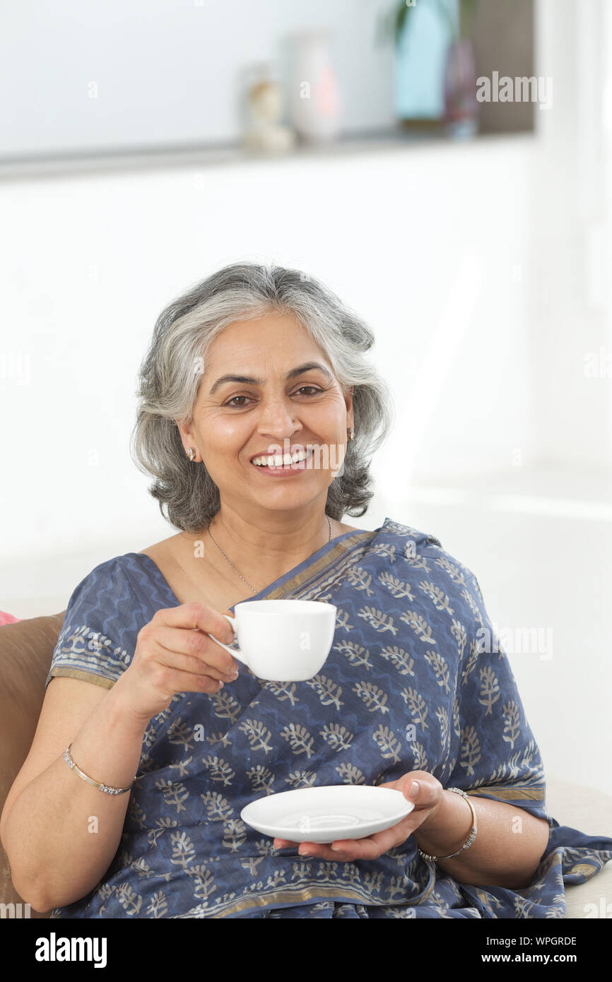Indian woman drinking tea hi-res stock photography and images - Alamy