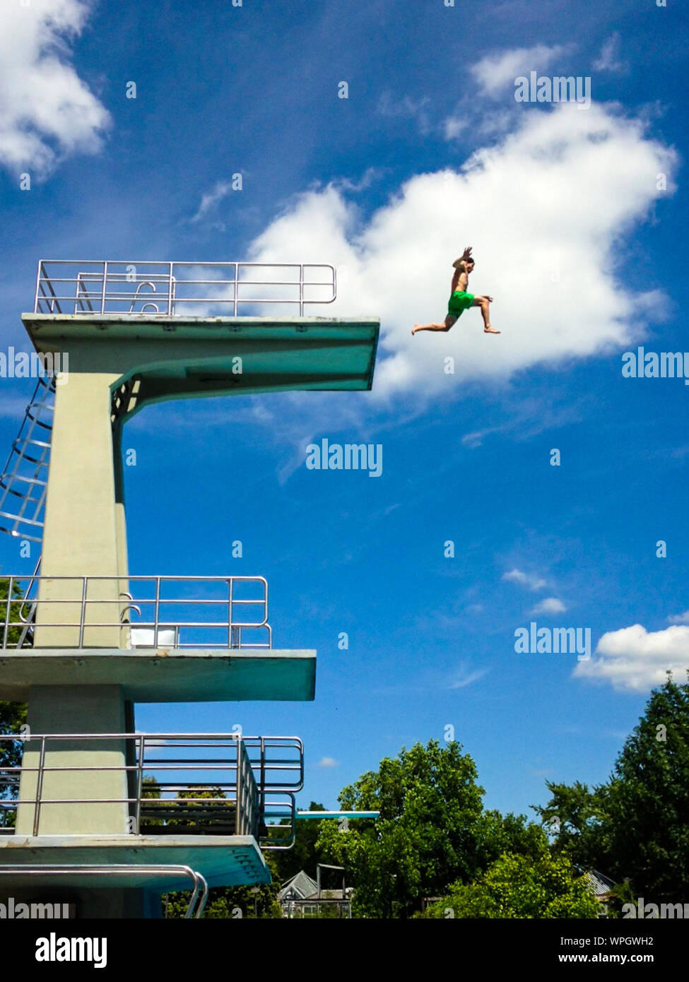 Man Jumping From A High Dive Platform Stock Photo - Alamy